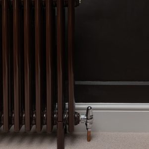 Close up of lockshield on valve set attached to chocolate brown multi-column radiator