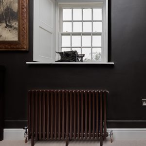 Windsor multi-column radiator in chocolate brown on black wall