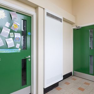 Vertical LST Ultra radiator with 2mm protective casing in school hallway